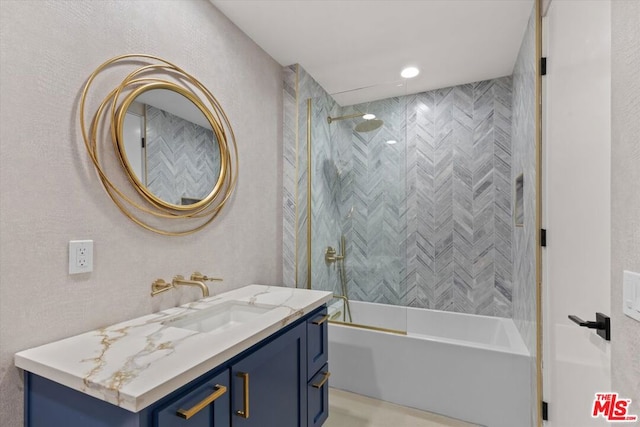 bathroom with vanity and tiled shower / bath