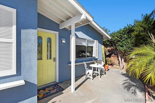 property entrance featuring a patio area