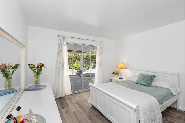 bedroom featuring light hardwood / wood-style floors and access to exterior