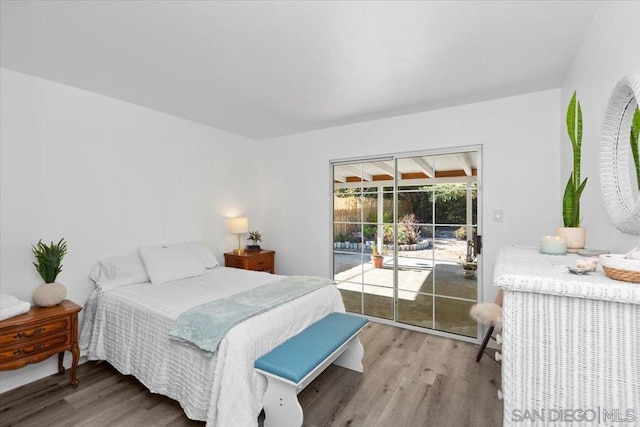 bedroom featuring light wood-type flooring and access to exterior