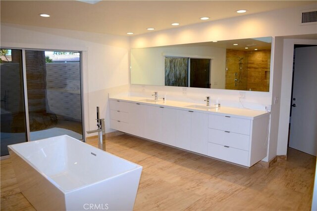 bathroom featuring vanity and separate shower and tub