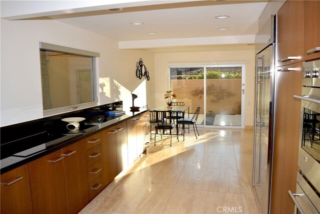 kitchen featuring oven and light tile patterned floors