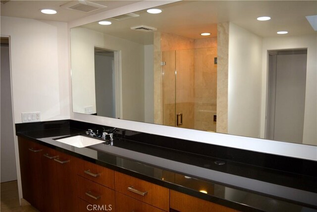 bathroom featuring vanity and walk in shower