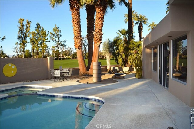 view of swimming pool with a patio area