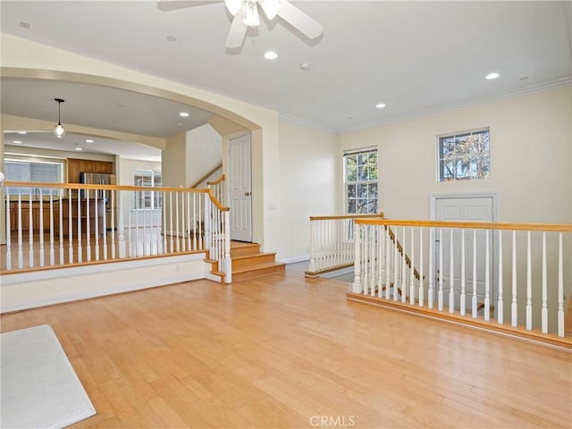 empty room featuring crown molding, ceiling fan, and light hardwood / wood-style flooring