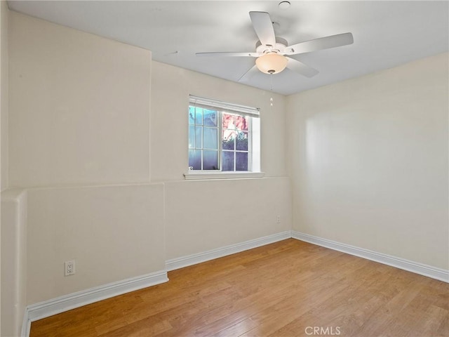 spare room featuring light hardwood / wood-style floors and ceiling fan