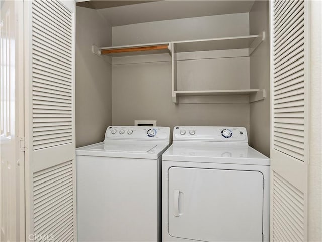 washroom with washing machine and clothes dryer