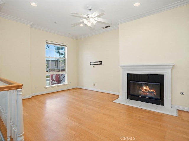 unfurnished living room featuring ornamental molding, ceiling fan, and light wood-type flooring