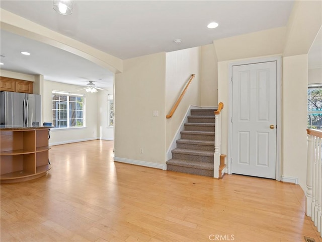 interior space with ceiling fan, plenty of natural light, and hardwood / wood-style flooring