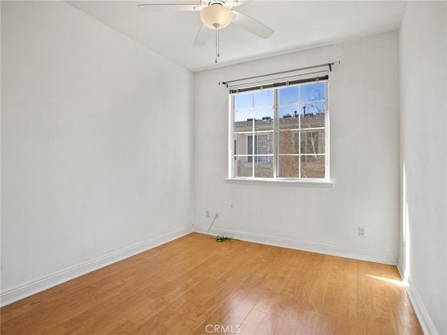 empty room with light hardwood / wood-style floors and ceiling fan