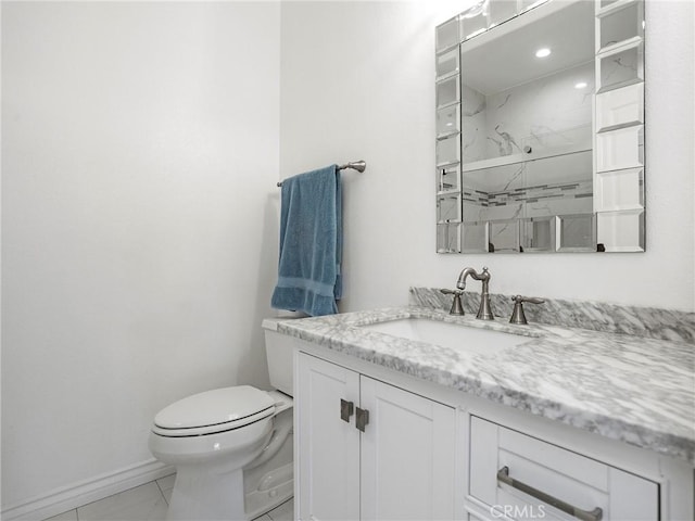 bathroom with toilet, walk in shower, and vanity