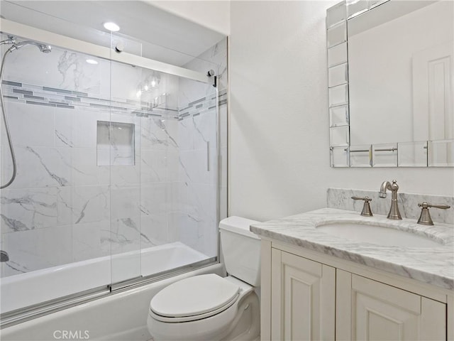 full bathroom with shower / bath combination with glass door, toilet, and vanity