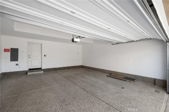 garage featuring a garage door opener and electric panel