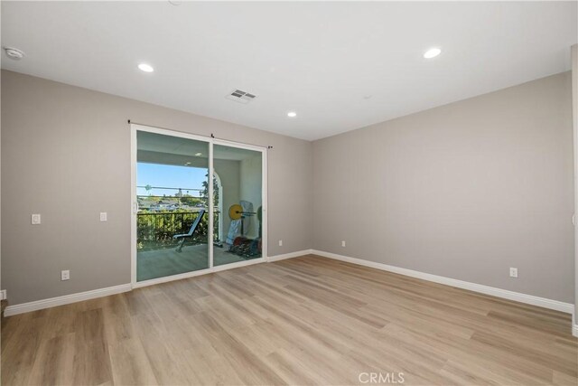 empty room with light hardwood / wood-style flooring