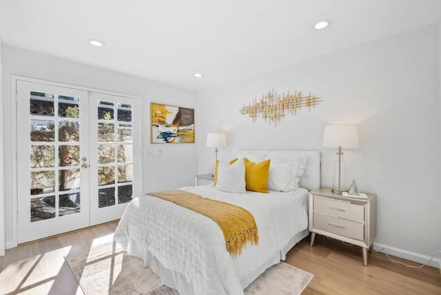 bedroom with light hardwood / wood-style floors and french doors