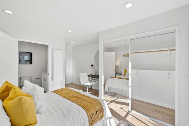 bedroom with hardwood / wood-style floors and a closet