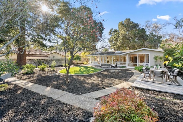 rear view of property with a sunroom