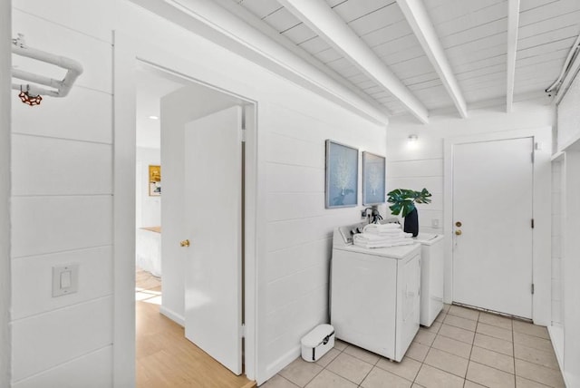 clothes washing area with light tile patterned floors, washer and clothes dryer, and wood ceiling