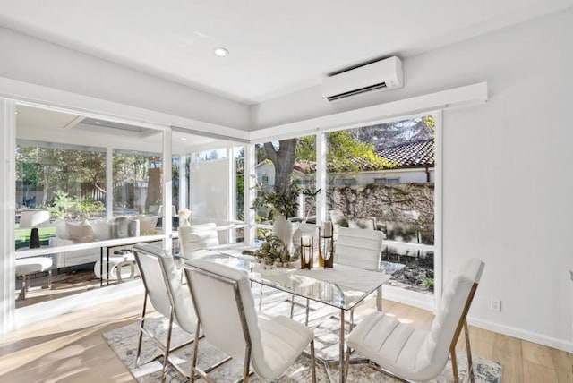 sunroom / solarium featuring a healthy amount of sunlight and a wall unit AC