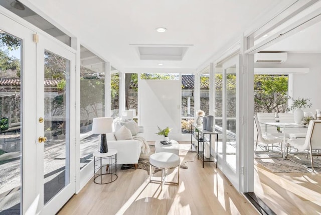 sunroom / solarium featuring an AC wall unit and a healthy amount of sunlight