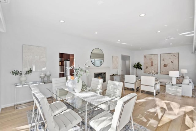 dining space with light hardwood / wood-style flooring