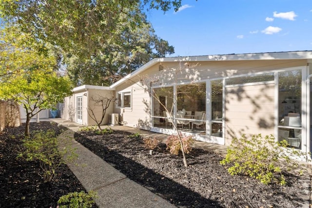 rear view of property with a sunroom