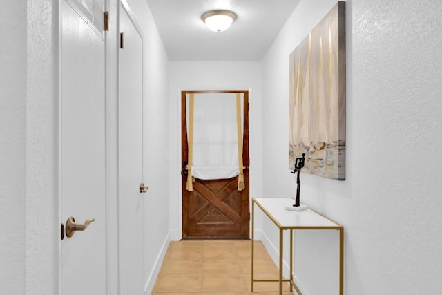 hall with light tile patterned floors