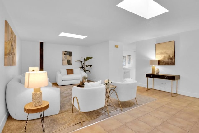 living room featuring a skylight and light tile patterned floors