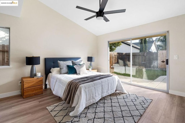 bedroom featuring access to outside, ceiling fan, vaulted ceiling, and hardwood / wood-style floors