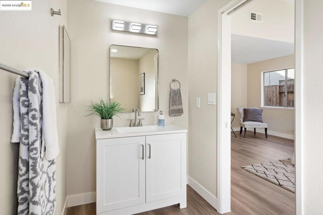 bathroom featuring hardwood / wood-style flooring and vanity