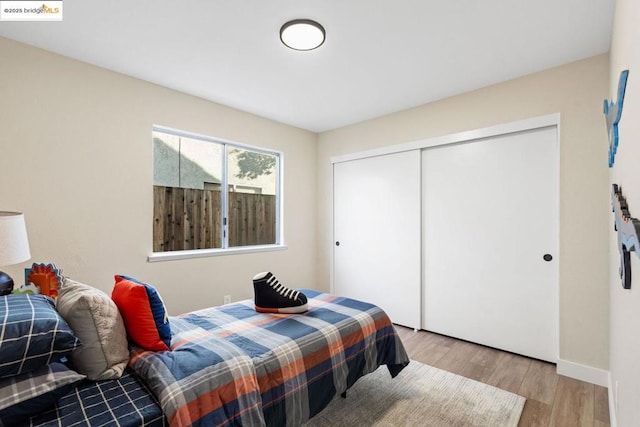 bedroom featuring light wood-type flooring and a closet