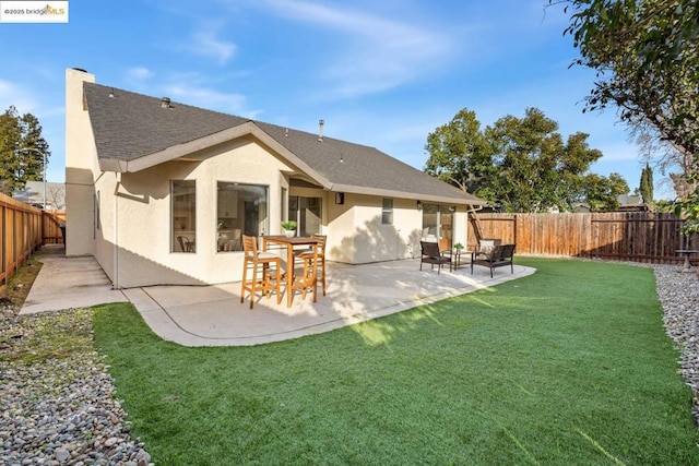 rear view of property featuring a patio area and a lawn