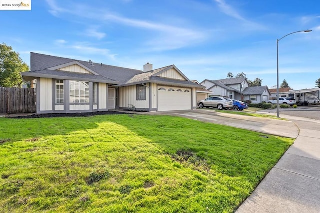 ranch-style house with a front yard and a garage