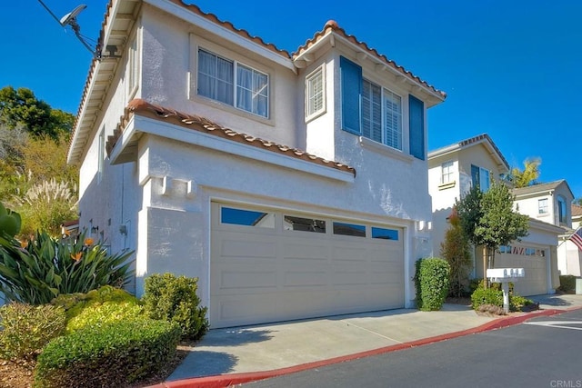 mediterranean / spanish-style home featuring a garage