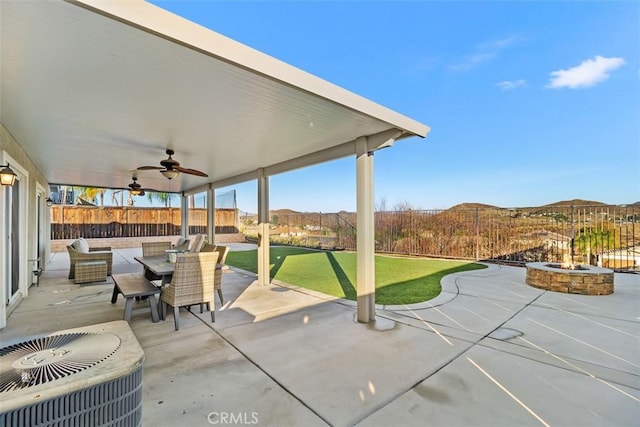 view of patio / terrace with ceiling fan, central AC unit, and a mountain view