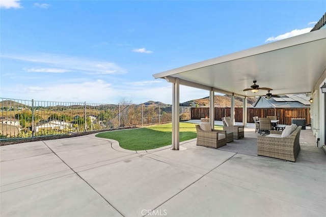 view of patio with ceiling fan, a mountain view, and outdoor lounge area