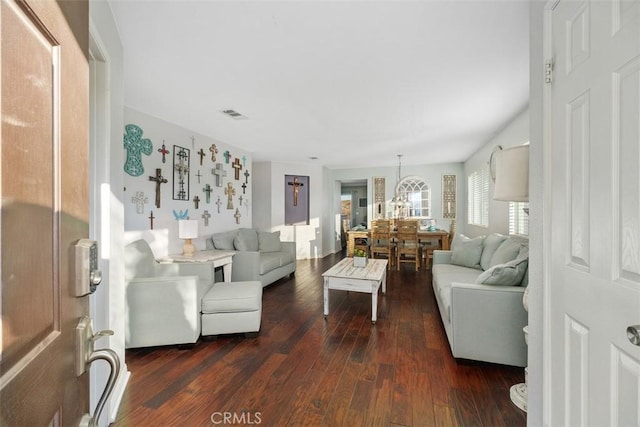 living room featuring a chandelier and dark hardwood / wood-style floors