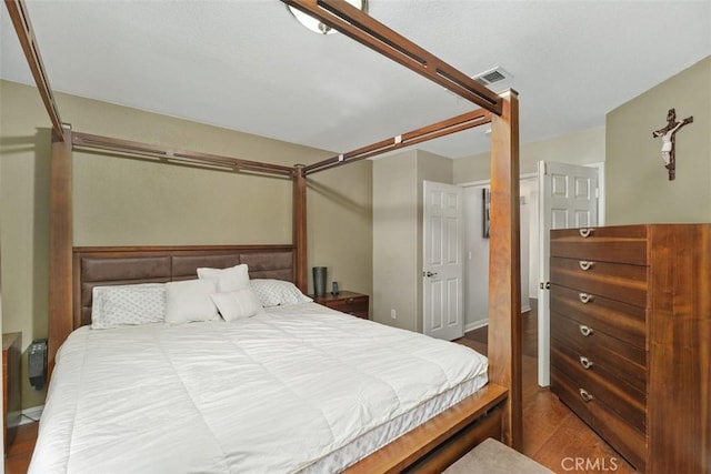 bedroom featuring dark hardwood / wood-style flooring