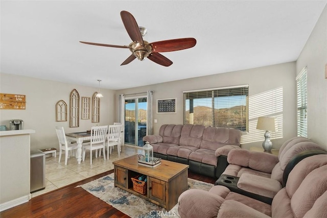 living room with light wood-type flooring and ceiling fan