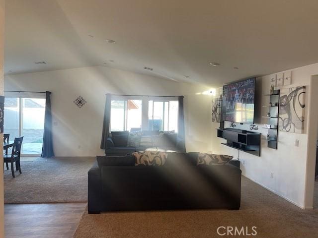 carpeted living room with lofted ceiling