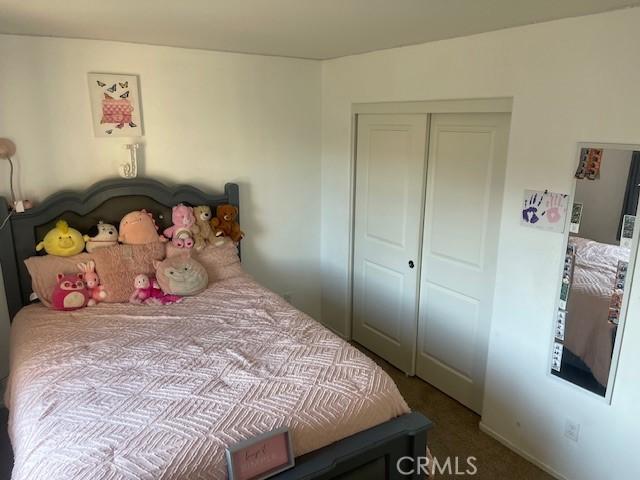 carpeted bedroom with a closet