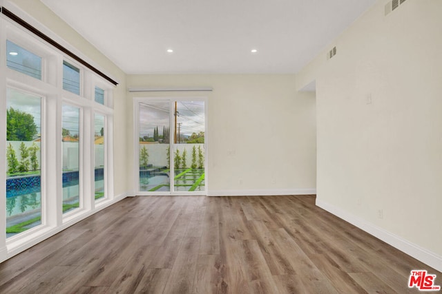 unfurnished room with light hardwood / wood-style flooring