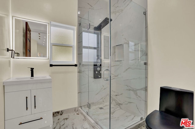 bathroom with a shower with door and vanity