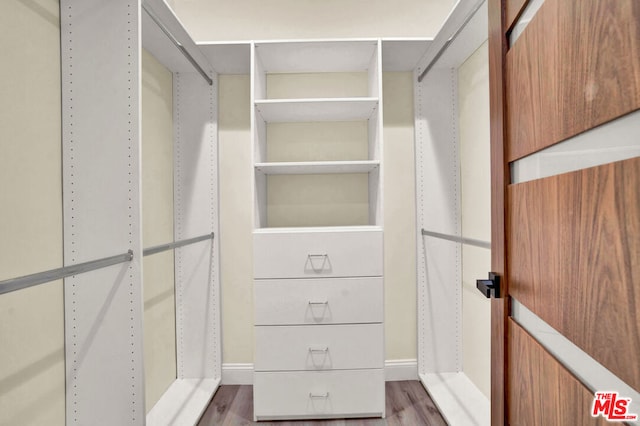 spacious closet featuring hardwood / wood-style floors