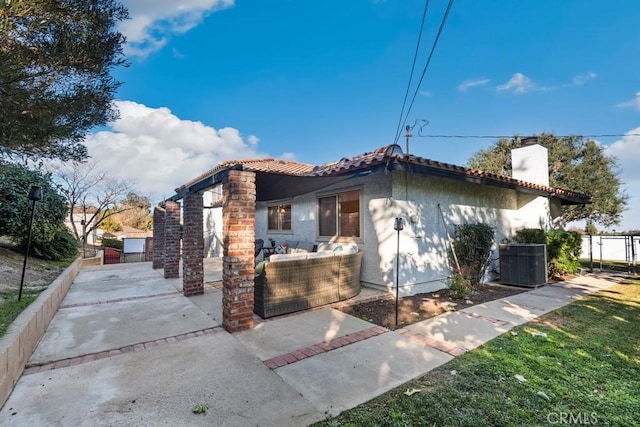 view of home's exterior with an outdoor hangout area, a patio, and central AC unit