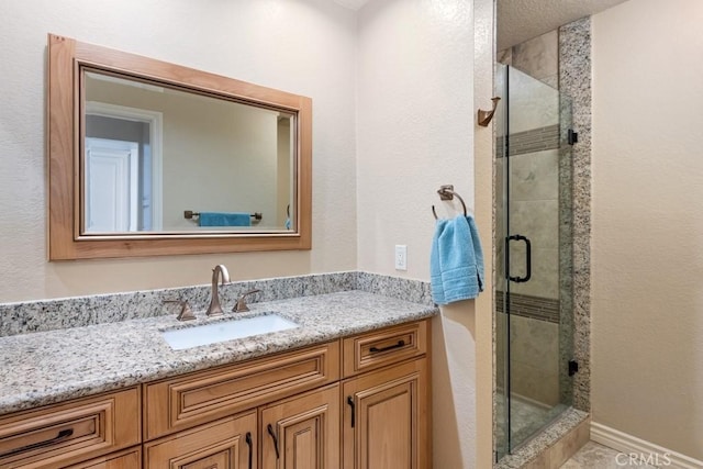 bathroom featuring walk in shower and vanity