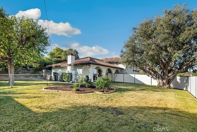 rear view of property featuring a lawn