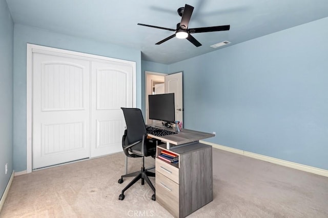 carpeted office with ceiling fan