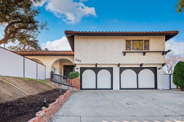 mediterranean / spanish house with a garage