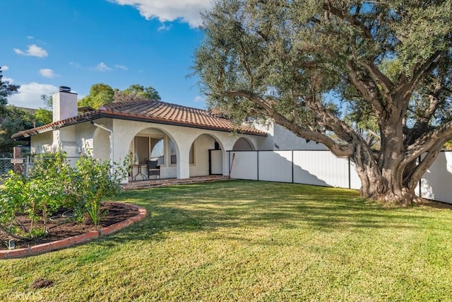 back of property featuring a lawn